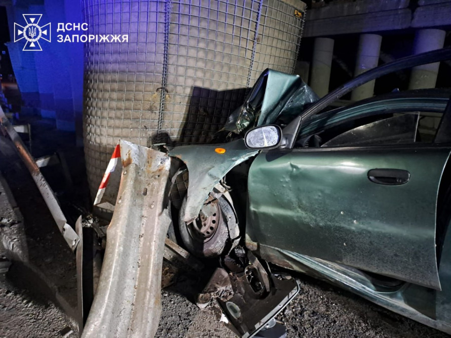 У Запоріжжі сталася нічна ДТП: водія «Ланоса» деблокували з понівеченої автівки після зіткнення з опорою (фото)