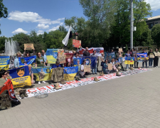 Берці та світлини на маскувальній сітці - у центрі Запоріжжя відбулася акція-перформанс на підтримку полонених (фото)